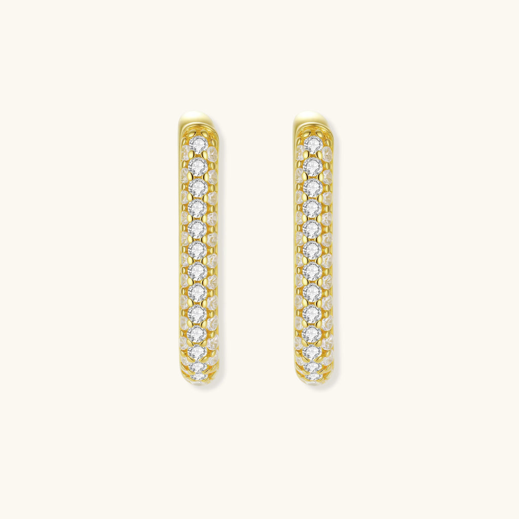 Close-up of small sterling silver huggie hoops completely covered in sparkling clear crystals with hinged closure